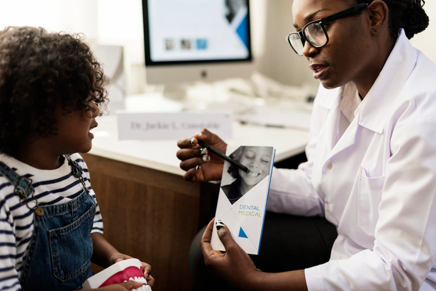 african-kid-having-conversation-with-doctor_53876-39351